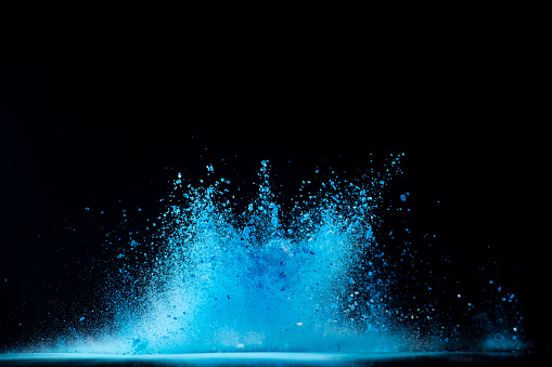 colorful powder dye explodes on black background captured in high speed