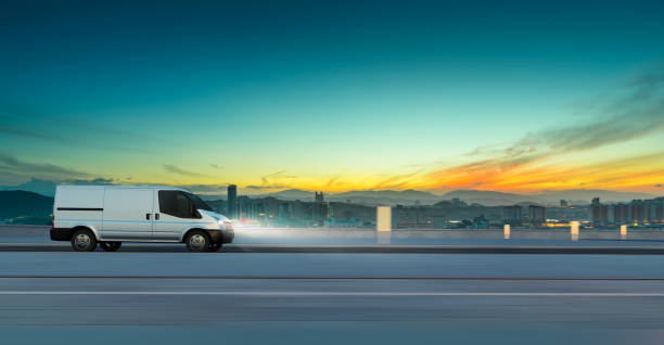 istock Van delivery on road at sunrise 1453704444