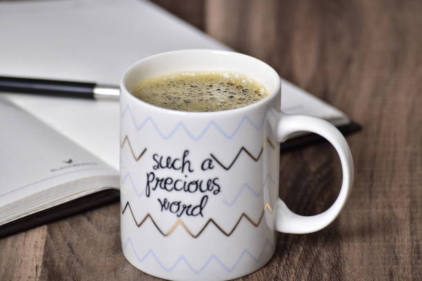 istock Black coffee mug on quote mug at office table 1453706891