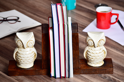 still life image of bookend at office table, wooden book holder