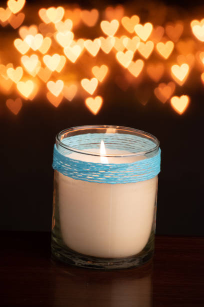 istock White candle jar on yellow light defocused background 1453707004