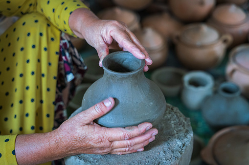 Close focus hands molding clay for making pottery vase in traditional pottery village Bau Truc - Phan Rang city, Ninh Thuan province, central Vietnam