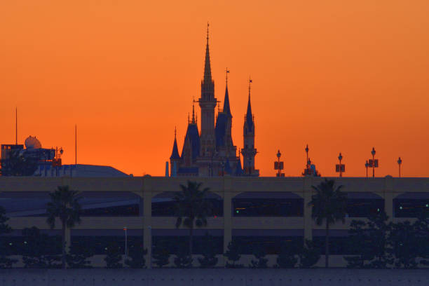 Tokyo, Japan-January 1, 2023: The first sunrise of the year 2023 over Cinderella Castle of Tokyo Disneyland, which was taken on the morning of January 1, 2023, from across a part of Tokyo Bay at Kasai Rinkai (Seaside) Park, Edogawa Ward, Tokyo, by telephoto lens.