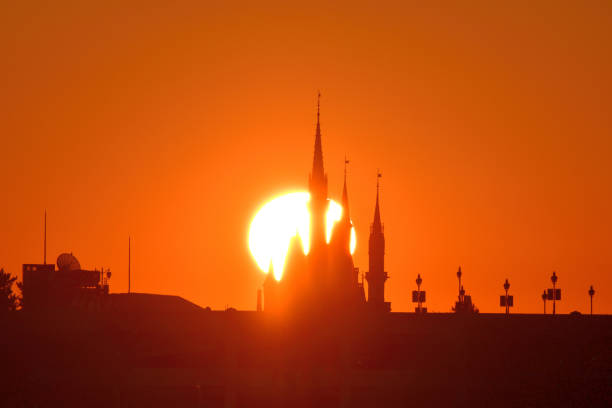 Tokyo, Japan-January 1, 2023: \nThe first sunrise of the year 2023 over Cinderella Castle of Tokyo Disneyland, which was taken on the morning of January 1, 2023, from across a part of Tokyo Bay at Kasai Rinkai (Seaside) Park, Edogawa Ward, Tokyo, by telephoto lens.