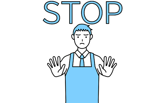 A man in an apron with his hand out in front of his body, signaling a stop.