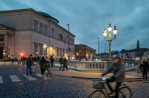 Copenhagen, Denmark - 3rd December 2022: Locals and tourists cycling on the street in city center of Copenhagen. Copenhagen is one of the most popular cities in world to tourists for its relaxed city life and beautiful scenes.