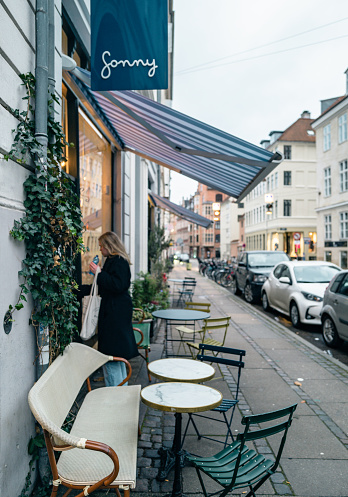 Copenhagen Denmark August 28th 2019 -  Outside Area with Chairs and Tables and pedestrians walking past