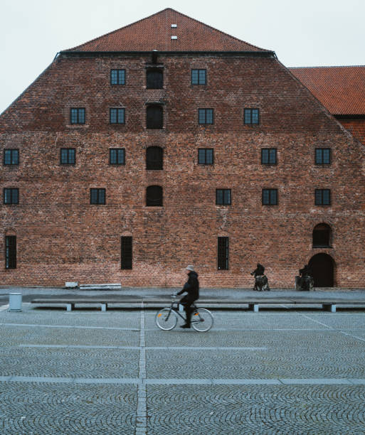 Copenhagen, Denmark - 3rd December 2022: Locals and tourists cycling on the street in city center of Copenhagen. Copenhagen is one of the most popular cities in world to tourists for its relaxed city life and beautiful scenes.