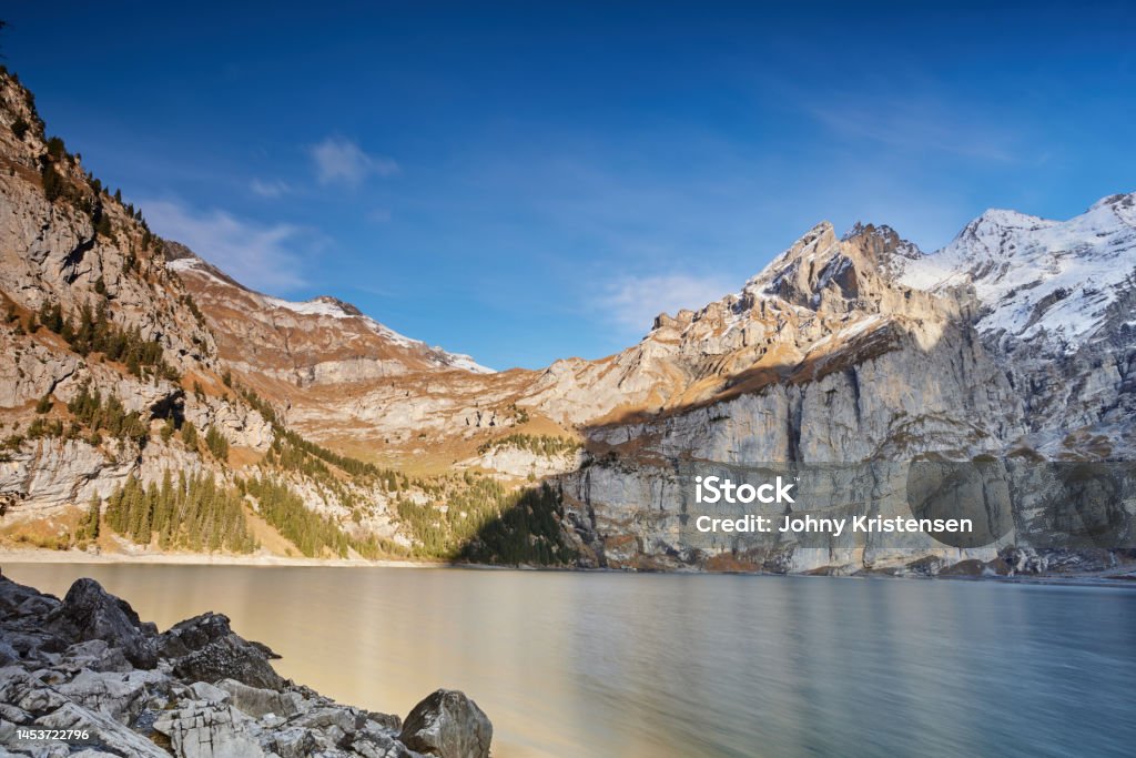 landscape of Oeschinen Lake from Heuberg Amazing blue lake with large mountain in Schweiz Blue Stock Photo