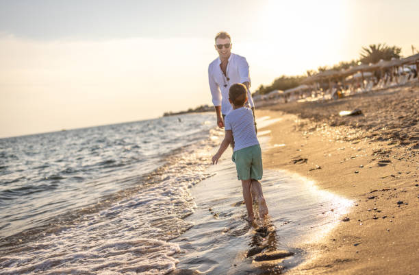 istock Enjoying a day with dad at the beach 1453723767