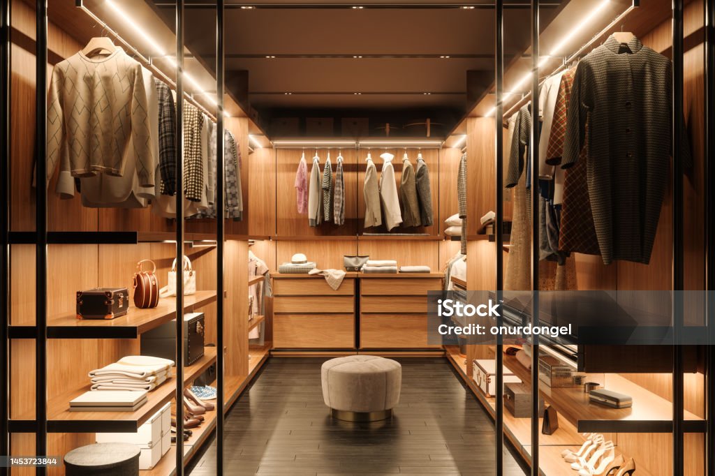 Dressing Room Interior With Shoes, Bags And Hanging Clothes Closet Stock Photo