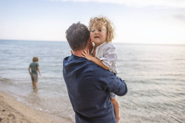 istock Father and son enjoying summer holidays at the beach 1453724082