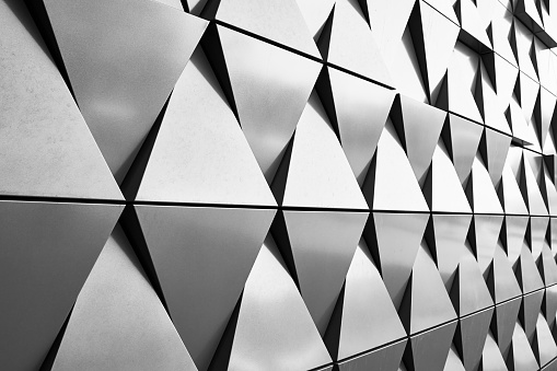 Closeup low angle view of modern corporate glass building, Sydney Darling Harbour, black and white, background with copy space, full frame horizontal composition