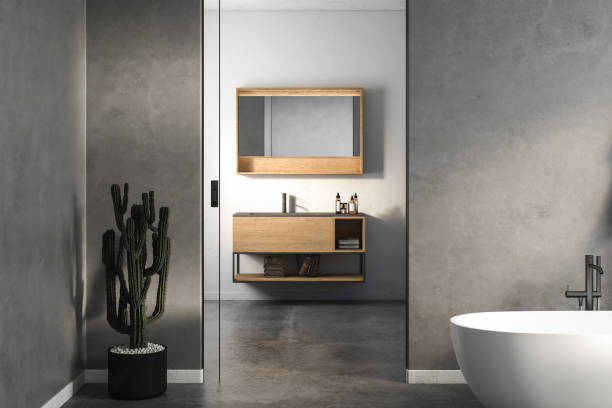 istock Modern minimalist bathroom interior, modern bathroom cabinet, white sink, wooden vanity, interior plants, bathroom accessories, bathtub, white and concrete walls, concrete floor. 3d rendering 1453726565