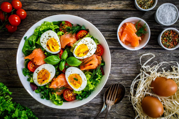istock Smoked salmon with boiled eggs and leafy vegetables on wooden table 1453726589