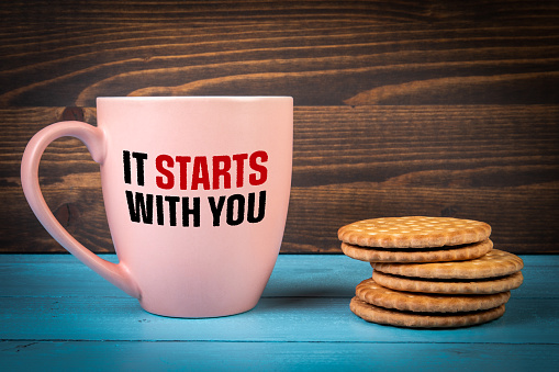 It Starts With You. Text on a coffee mug.