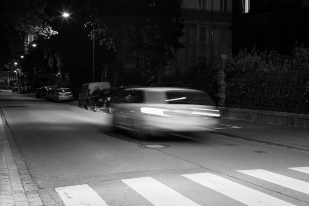 istock Black and white shot of a fast car at night 1453729005