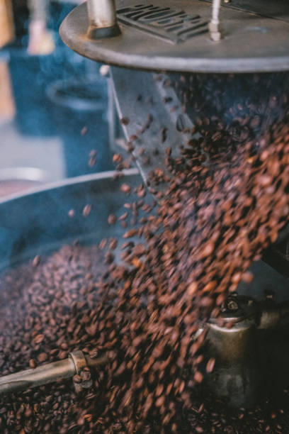 istock Vertical closeup shot of the working coffee bean roaster machine 1453730085