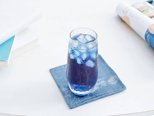 istock Selective focus shot of blue cocktail with ice cubes on a table 1453730542