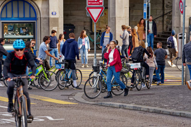 Group of cyclists at Minster Bridge at the old town of Zürich on a sunny autumn day. Photo taken October 30th, 2022, Zurich, Switzerland.