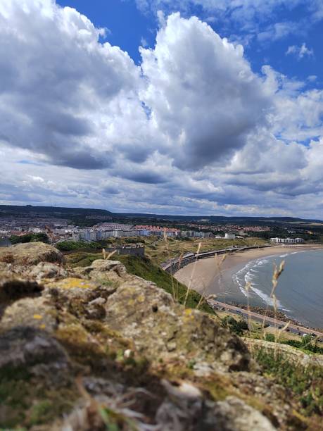 istock Vertical shot of a cloudy sky over a coastal town 1453731939