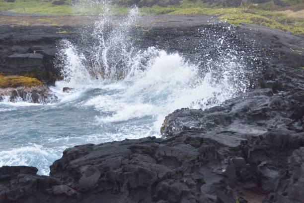 istock Waves crashing onto the rocks on the beach 1453733866