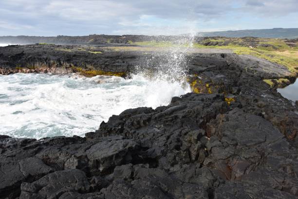 istock Waves crashing onto the rocks on the beach 1453733876