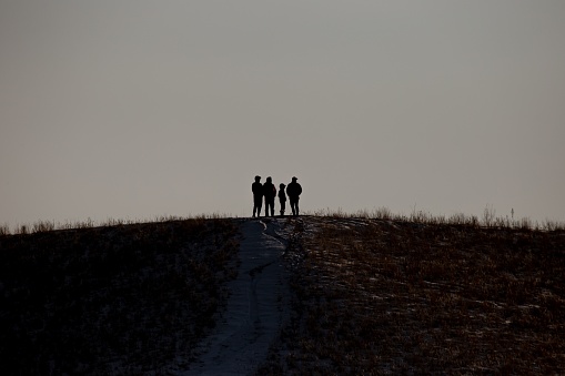 A beautiful view of silhouettes of people on hill top