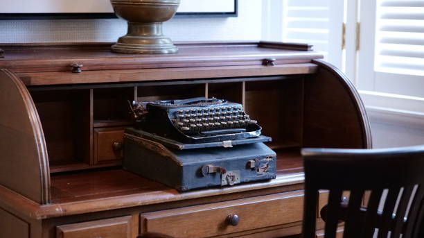 istock Closeup of an old vintage typing machine on a brown working table 1453736130