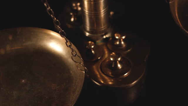 Closeup of antique measuring scales on a dark background - concept of law and justice