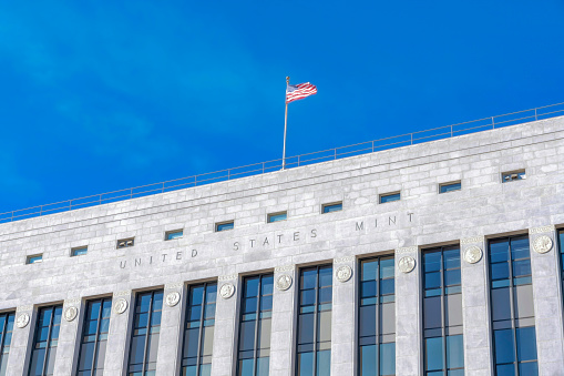 SAN FRANCISCO, CALIFORNIA - CIRCA OCTOBER, 2021: United States Mint building against blue sky. Facade a historic government building that produces coinage used as money in the USA.