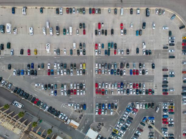 parking. aerial view of cars parked in line in a parking lot. colored cars. drone view - parking lot imagens e fotografias de stock