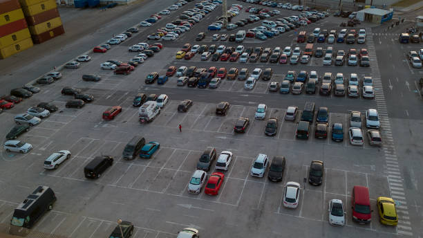 parking. aerial view of cars parked in line in a parking lot. colored cars. drone view - parking lot imagens e fotografias de stock