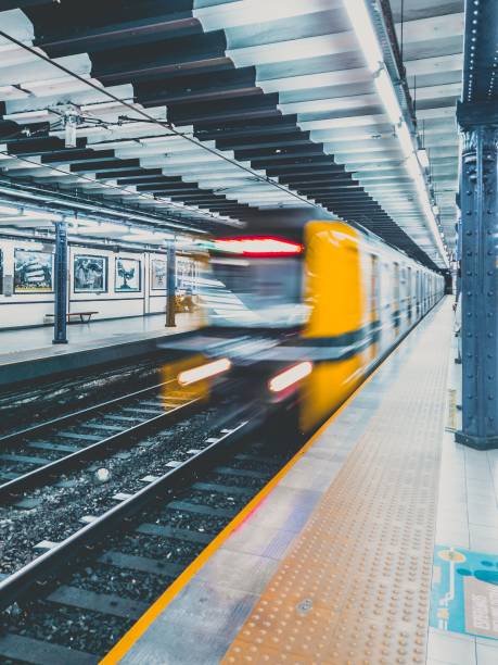 istock Yellow train in motion in railway station platform 1453738948