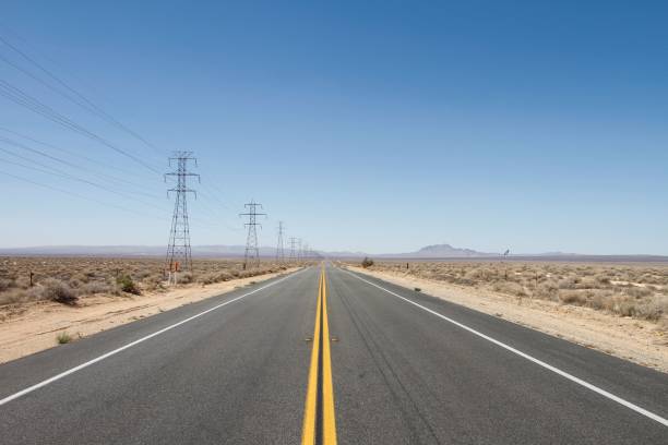 istock Empty highway road with dry plant fields on each side on a sunny day 1453740306