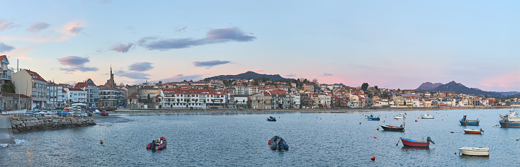 A Panoramic view of the fishing port of a small town with boats in the sea in Galicia, Spain.