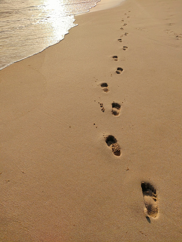 Footprints in the sand, close up. Maldives.