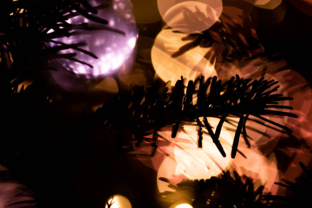 istock Christmas tree branches close up decorated with garland lights 1453744264