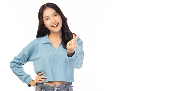 Smiling young girl showing mini heart with hand sign, love sign Isolated over white background Portrait young beautiful asian woman hand gesturing in heart shape Smile face asian girl get in love