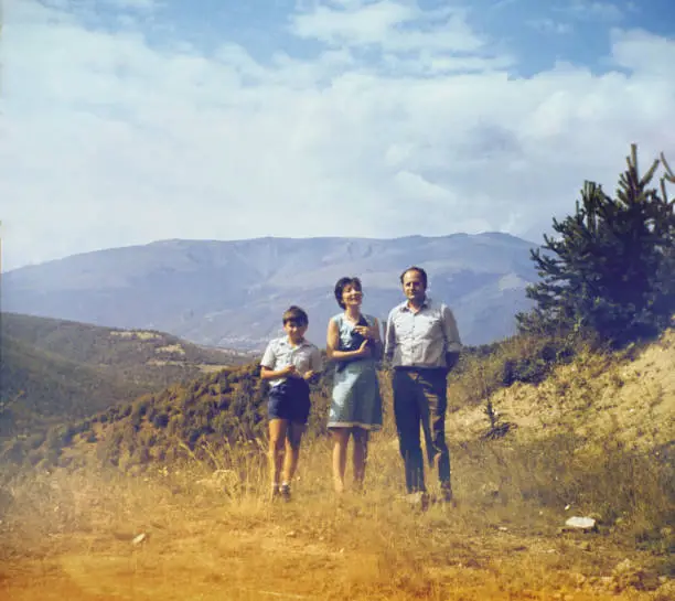 Vintage Photo of Family in the Rodopa Mountain, Bulgaria. The picture was taken in the spring 1974 year. The camera is on tripod and set to self-timer.