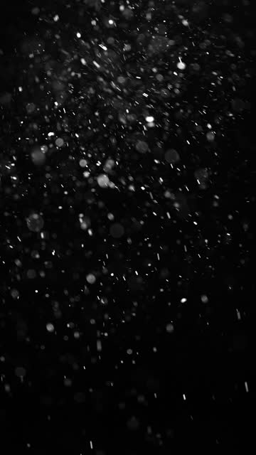 Floating dust particles on a black background