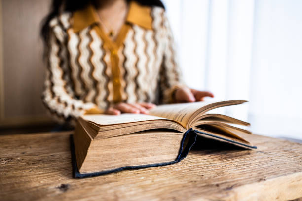 istock Asian women reading a book at home 1453747028
