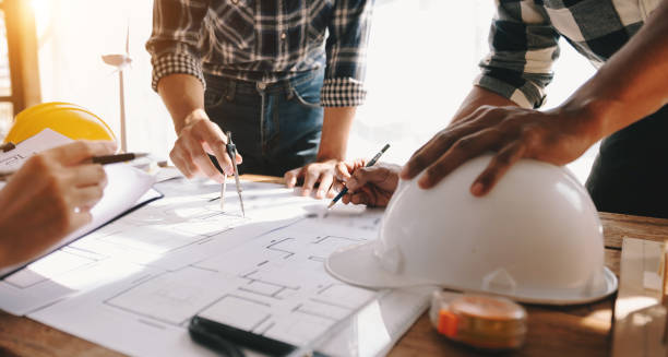 istock Confident team of architect working together in a office.Then discussing about new startup project on desk.in office, architectural concept 1453748302