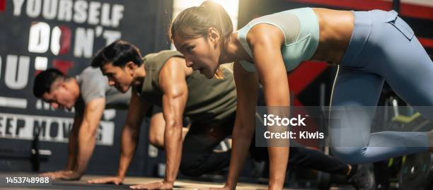 Group Of Young Athlete Male And Female Exercising Together In Fitness Attractive Handsome Sportsman And Sportswomen Working Out By Pushups To Maintain Strong Muscle For Health Care In Gymnasium Stock Photo - Download Image Now