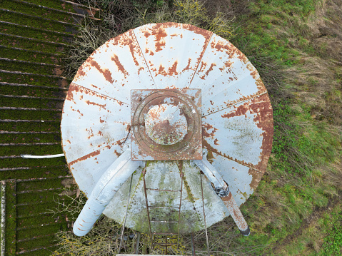 Drone view of an old and rusty grain silo structure seen on a dairy farm in the UK.