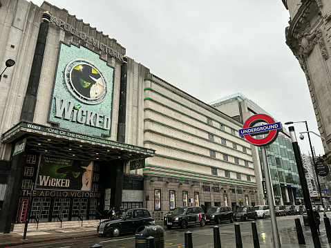 The entrance and sign for the Musical Wicked at the Apollo Victoria theatre in London. Wicked The Musical. Apollo Victoria Theatre - Long-running, big-name musicals showing in marine-themed, art deco former cinema. Victoria underground station sign view.