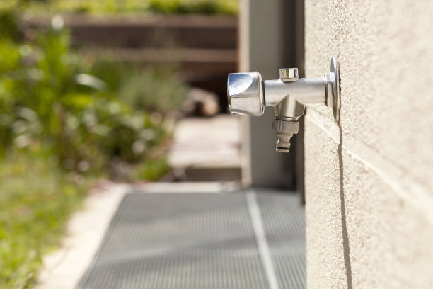 Faucet Outside on house wall, outdoor garden Water Tap against brick wall.