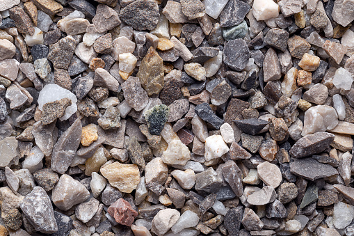 Road and plaster grit, loose chippings, crushed stone, surface, macro photo. Dry lime- and iron-free quartz sand, used as spreading grit, or as an aggregate for concrete ballast, plaster and masonry.