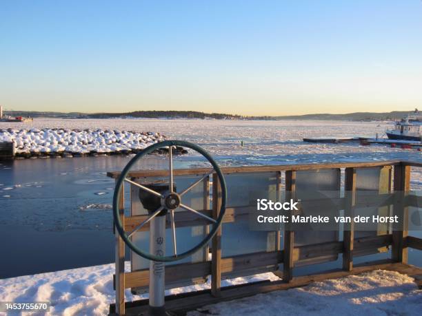 Ship Steering Wheel And A Partially Frozen Oslofjord In Winter Stock Photo - Download Image Now