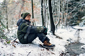 Portrait of a teenage boy hiking in winter forest